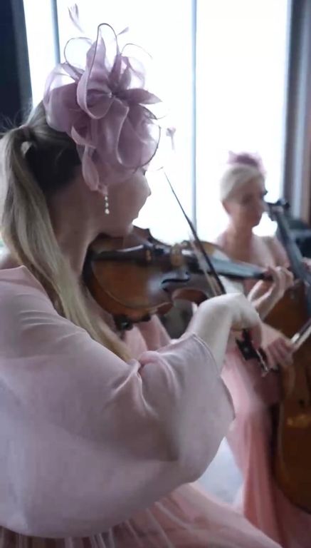 Pembe elbiseli keman sanatçısının canlı müzik performansı.